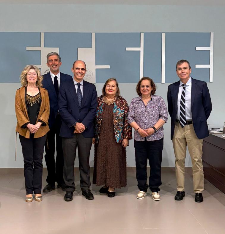 Fotografía de D. Vicente con el tribunal. De fondo se puede leer "ETSIE" pintado sobre la pared.