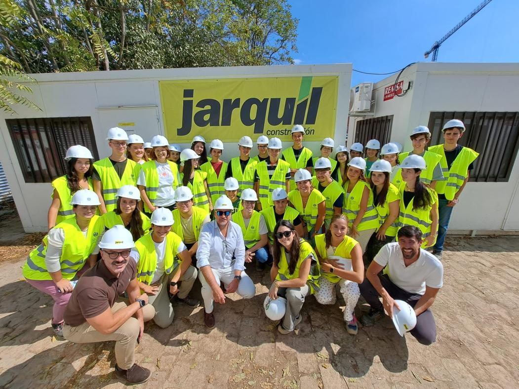Fotografía del alumnado participante delante del cartel de la empresa Jarquil